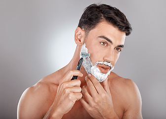 Image showing Grooming, foam and shaving with face of man with razor for beauty, hygiene and skincare with morning routine. Self care, facial and shave beard with model and cream product for wellness and cleaning