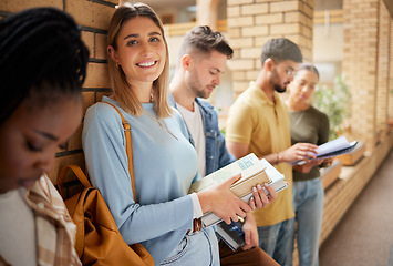 Image showing University, lobby and portrait of woman and students standing in row together with books at business school. Friends, education and future, girl from USA in study group on campus in corridor for exam