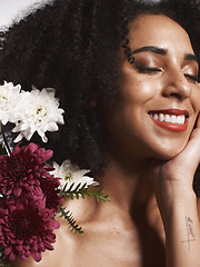 Image showing Wellness, flowers and beauty aesthetic model with skincare satisfaction and glowing texture routine. Aesthetic, health and makeup of black woman cosmetics model with beautiful smile in white studio