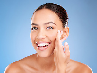 Image showing Face portrait, beauty skincare and woman in studio isolated on a blue background. Makeup, cosmetics and young female model with healthy, glowing and flawless skin after luxury spa facial treatment.