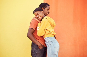 Image showing Couple, love or bonding hug by city wall background in trust, security or support in relax urban date, fun activity or holiday. Portrait, happy smile or black woman and man embrace on building mockup