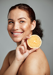 Image showing Woman, happy and orange in studio for skincare, wellness and beauty with cosmetic glow, self care and backdrop. Model, black woman and fruit for aesthetic, detox or healthy natural skin by background
