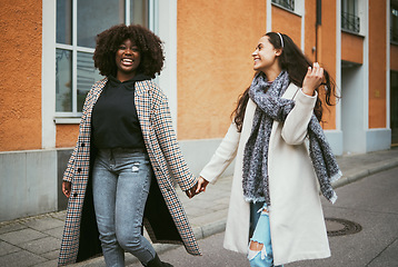 Image showing Travel, holding hands and lesbian couple walking in street enjoying holiday, vacation and adventure. Fashion, lgbtq relationship and women dating for happy lifestyle, freedom and relaxing on weekend