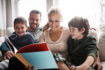 Image showing Family, couple and children on sofa for storytelling time with books and learning in family home. Love, reading and children, mother and father with fantasy book on couch, smile and fun in apartment.