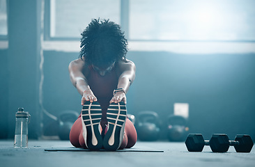 Image showing Fitness, mockup and a black woman stretching in the gym with dumbbells while holding her feet. Health, exercise and weightlifting with a female athlete doing her warm up routine in a workout center