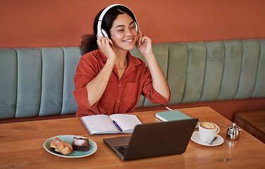 Image showing Headphone, cafe and black woman with music or web podcast working on a computer. Student learning, streaming and radio listening of a happy young person at a coffee shop ready for digital study