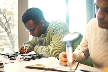 Image showing Students, writing or notebooks in school test, university campus exam or college degree notes in classroom library. Men, friends or people with textbook for learning, thinking education or studying