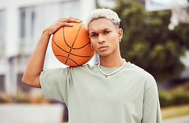 Image showing Basketball, young man and basketball player with sport in park with portrait in city and exercise outdoor. Fitness, athlete on basketball court, focus and urban with sports motivation and training.