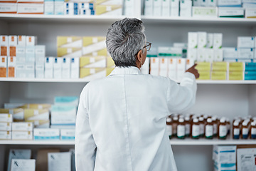 Image showing Pharmacy pills, pointing and senior pharmacist with product choice, medicine box or pharmaceutical medication drugs. Retail medical store, healthcare and back of elderly woman point at shop shelf