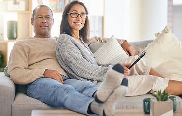 Image showing Mature couple, tablet and relax portrait on sofa together for love, support and romance bonding in living room at home. Man smile, happy woman, and romantic quality time on couch with tech device