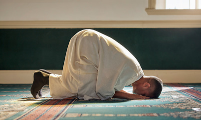 Image showing Islam, religion and prayer of a muslim man at mosque in ramadan for spiritual faith, God and belief while doing religious worship. Islamic or Arab culture people sitting to pray at holy place