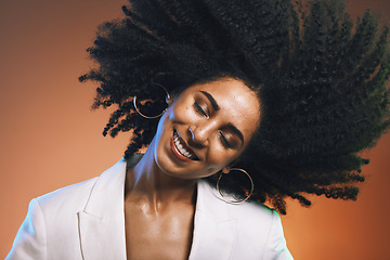 Image showing Hair, afro and black woman, beauty with smile on face and cosmetic and hair care with happiness against studio background. Dance, natural curly hair texture and makeup with earrings and freedom