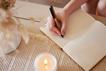 Image showing Hand, candle and woman writing in journal with top view for calm, peace mindset and relax morning routine in home. Hands, notebook and diary planning goals, idea vision or creative writer lifestyle