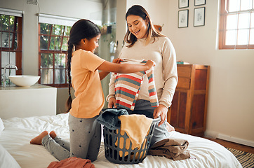 Image showing Laundry, pregnant mother and child help with house chores and cleaning with love and care. Folding clothes, happy and working family in a bedroom bed busy with clean clothing fold in a house