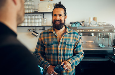 Image showing Man, barista helping customer and service in coffee shop, conversation and friendly entrepreneur. Guy, male employee or assist client in cafe, talking or order tea with successful business or startup