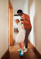 Image showing Learning, skateboard and fun with father and daughter in their house, happy and smile while holding for balance. Skating, playing and girl with parent on a board, laughing and teaching in their home