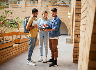 Image showing University, students and friends with textbook for project study, education or sharing information together at the campus. Group of college people reading book with smile for learning or scholarship