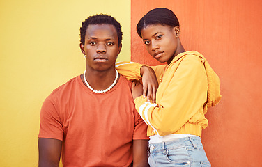 Image showing Fashion portrait of African couple, people or friends relax with designer brand clothes, casual style and luxury apparel. Urban gen z aesthetic, black woman and man on orange yellow background wall