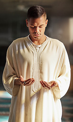 Image showing Man, muslim faith and praying in mosque for God, peace and mindfulness with traditional islamic clothes. Islam worship, prayer and spiritual balance for ramadan, religion and gratitude in Doha, Qatar