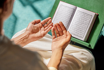 Image showing Quran, muslim and man hands praying to allah, god or holy spirit for islamic religion, faith and Saudi Arabia Hajj. Spiritual book, Eid hope prayer and Islamic person worship in moslem mosque church