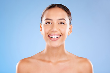 Image showing Face portrait, beauty skincare and woman in studio isolated on a blue background. Makeup, cosmetics and young female model with healthy, glowing and flawless skin after luxury spa facial treatment.