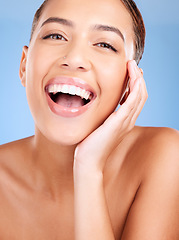 Image showing Face portrait, beauty skincare and woman in studio isolated on a blue background. Makeup, cosmetics and young female model with healthy, glowing and flawless skin after luxury spa facial treatment.