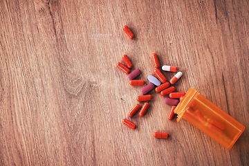 Image showing Medicine, pills and healthcare with supplements or vitamin tablets for health with pill zoom on wood table. Healthy, health insurance and prescription medication with medical care and pharmaceutical