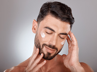 Image showing Man, face and beauty with cream for skincare, moisturizer and skin lotion with cosmetics mockup against studio background. Grooming with hands for cosmetic care, facial treatment with wellness.