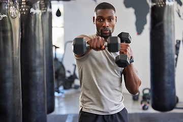 Image showing Portrait, dumbbell and fitness with a black man bodybuilder in a gym for a workout or exercise. Health, training or weightlifting with a male athlete or personal trainer exercising in a sports center