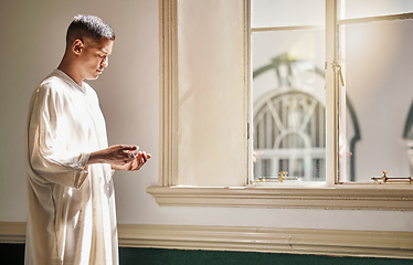 Image showing Muslim, prayer or man in a mosque praying to Allah for spiritual mindfulness, support or wellness in Doha, Qatar. Religion, peace or Islamic person in temple to worship or praise God with gratitude