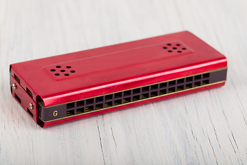 Image showing Harmonica on a wooden table