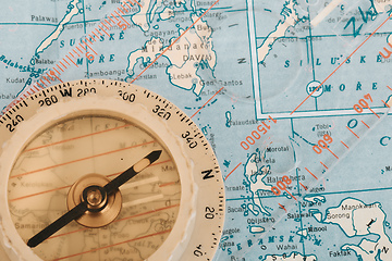 Image showing Transparent plastic compass on wooden background