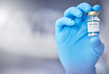 Image showing Innovation, healthcare or hand with vaccine, medicine or product in bottle with a blurry or blurred background. Monkey pox, doctor or scientist working on medical cure or lab drugs in safety gloves