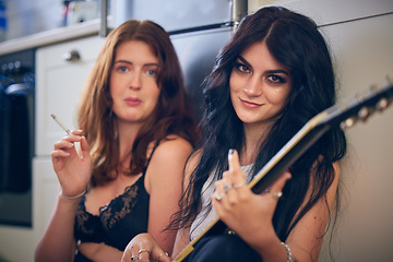 Image showing Guitar, smoking and women on the kitchen floor for music, social and entertainment in a house. Creative, acoustic and portrait of musician friends with an instrument for artistic creativity in a home