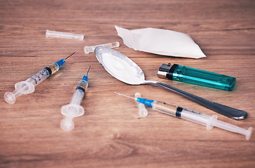 Image showing Powder, syringe and drugs with spoon on table for alcohol addiction, drug rehabilitation and narcotics abuse. Medicine, illegal drug and addict problem for meth, cocaine and heroin solution on desk