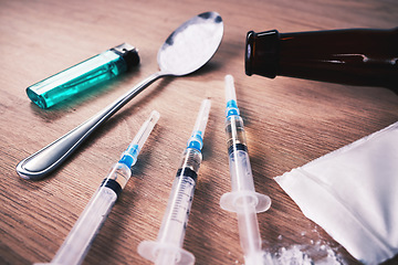 Image showing Drugs, syringe and podwer with spoon on table for alcohol addiction, drug rehabilitation and narcotics abuse. Medicine, illegal pharmaceuticals and meth, cocaine and heroin solution for drug problem