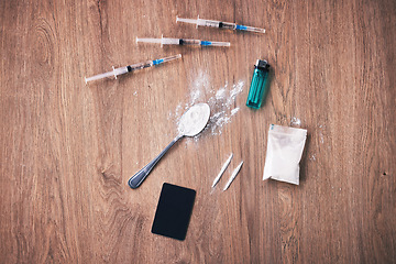 Image showing Powder, syringe and drugs with spoon on table for alcohol addiction, drug rehabilitation and narcotics abuse. Medicine problem, crime and illegal drug habit with liquid, cocaine and heroin solution