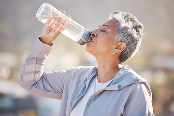 Image showing Fitness, health and senior woman drinking water for hydration on outdoor cardio run, exercise or retirement workout. Marathon training, bottle and profile of runner running in Rio de Janeiro Brazil