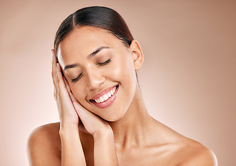 Image showing Skincare, beauty and relax, woman with eyes closed and smile on studio background. Makeup, glamour and luxury skin care with hands on beautiful face, natural cosmetics for detox facial on happy woman