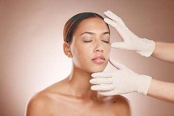 Image showing Plastic surgery, woman and doctor hands check face for botox, beauty implant and makeup cosmetics. Skincare consultation, facial and gloves for aesthetics, filler and body change on studio background