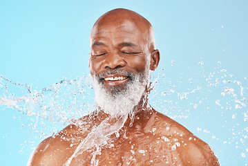 Image showing Relax, senior and black man with skincare cleaning routine and satisfied face with water splash. Mature cosmetic model washing body with smile for grooming hygiene on blue studio background.