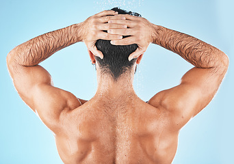 Image showing Water splash, man hair and shower for body hygiene, skincare grooming or cleaning care in blue background studio. Model back, self care water cleansing and cosmetics hair care wellness in morning