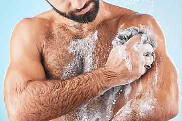 Image showing Shower, soap and man washing body for hygiene, cleaning health and fresh morning on a blue studio background. Skincare, water and cosmetics model showering to clean skin for healthy lifestyle