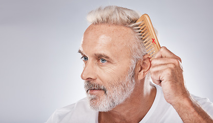 Image showing Cosmetics, senior man and brush hair for grooming, treatment and on grey studio background. Mature male, elderly guy and comb for hair styling, luxury and beauty for wellness, retirement and fresh