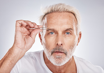 Image showing Man, face or eyebrow tweezing grooming on gray studio background for self care, healthcare wellness or beauty aesthetic. Portrait, mature model or hair removal tweezer in cleaning growth maintenance