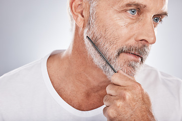 Image showing Beard comb, senior man and face on studio background for barber cleaning, body wellness and skincare. Male model brushing facial hair for healthy maintenance, aesthetic beauty and hair care cosmetics