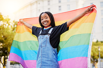 Image showing Black gay woman, rainbow flag and lgbtq pride with a smile for sexuality freedom, non binary and gender neutral lifestyle. Portrait of young lesbian girl in city of France for equality and love