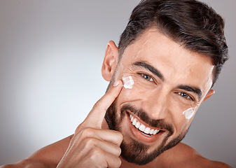 Image showing Man, face and cream for skincare and beauty closeup with sunscreen, facial portrait and moisturizer. Lotion, skin wellness and glow with happy model, cosmetic care mockup against studio background