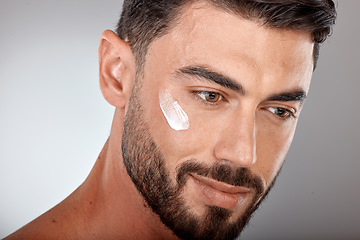 Image showing Man, face and cream for skincare and beauty closeup with sunscreen, facial treatment and moisturizer cosmetics. Lotion, healthy skin with wellness and glow, cosmetic care against studio background