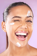 Image showing Woman face, skincare and beauty cream wink for dermatology, health and wellness of natural glow skin on purple background. Portrait of aesthetic cosmetic model in studio with secret sunscreen product